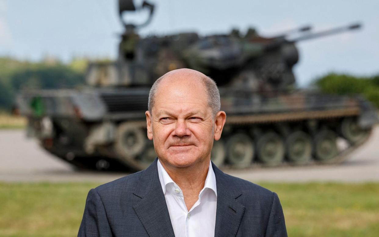 German Chancellor Olaf Scholz poses in front of a German self-propelled anti-aircraft gun Flakpanzer Gepard during a visit of the training program for Ukrainian soldiers on the Gepard anti-aircraft tank in Putlos near Oldenburg, on August 25, 2022. - Scholz meets with soldiers and industrial trainers from the manufacturing company Krauss-Maffei Wegmann at the Putlos military training area in Schleswig-Holstein. (Photo by Axel Heimken / POOL / AFP) (Photo by AXEL HEIMKEN/POOL/AFP via Getty Images) - AXEL HEIMKEN/POOL/AFP via Getty Images