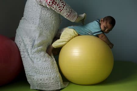 Physiotherapist Jeime Lara Leal does exercises with Lucas, 4-months old, who is Miriam Araujo's second child and born with microcephaly in Pedro I hospital in Campina Grande, Brazil , February 17, 2016. REUTERS/Ricardo Moraes