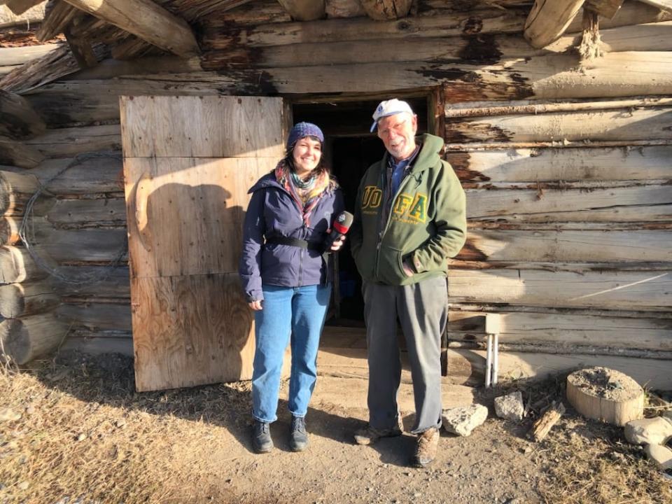 CBC associate producer Jordan Tucker and Rob Diether stand outside the root cellar on the Horse Lake Community Farm Co-Op located near Lone Butte in the province's Interior.