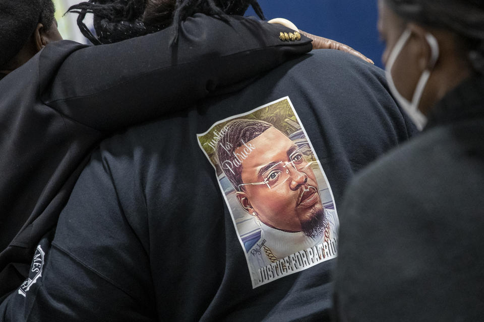 Family and friends react during the funeral for Patrick Lyoya at the Renaissance Church of God in Christ Family Life Center in Grand Rapids, Mich. on Friday, April 22, 2022. The Rev. Al Sharpton demanded that authorities publicly identify the Michigan officer who killed Patrick Lyoya, a Black man and native of Congo who was fatally shot in the back of the head after a struggle, saying at Lyoya's funeral Friday: “We want his name!" (Cory Morse/The Grand Rapids Press via AP)