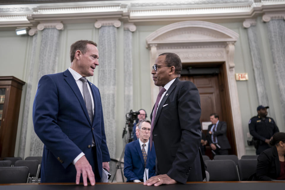 Sen. Ted Budd, R-N.C., left, speaks with Acting Administrator of the Federal Aviation Administration Billy Nolen as he appears before the Senate Commerce, Science, and Transportation Committee to examine recent failures in the FAA's NOTAM system, at the Capitol in Washington, Wednesday, Feb. 15, 2023. (AP Photo/J. Scott Applewhite)