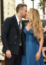 Actor Ryan Reynolds, left, and his wife, actress Blake Lively, share a kiss during a ceremony to award him a star on the Hollywood Walk of Fame on Thursday, Dec. 15, 2016, in Los Angeles. (Photo by Chris Pizzello/Invision/AP)