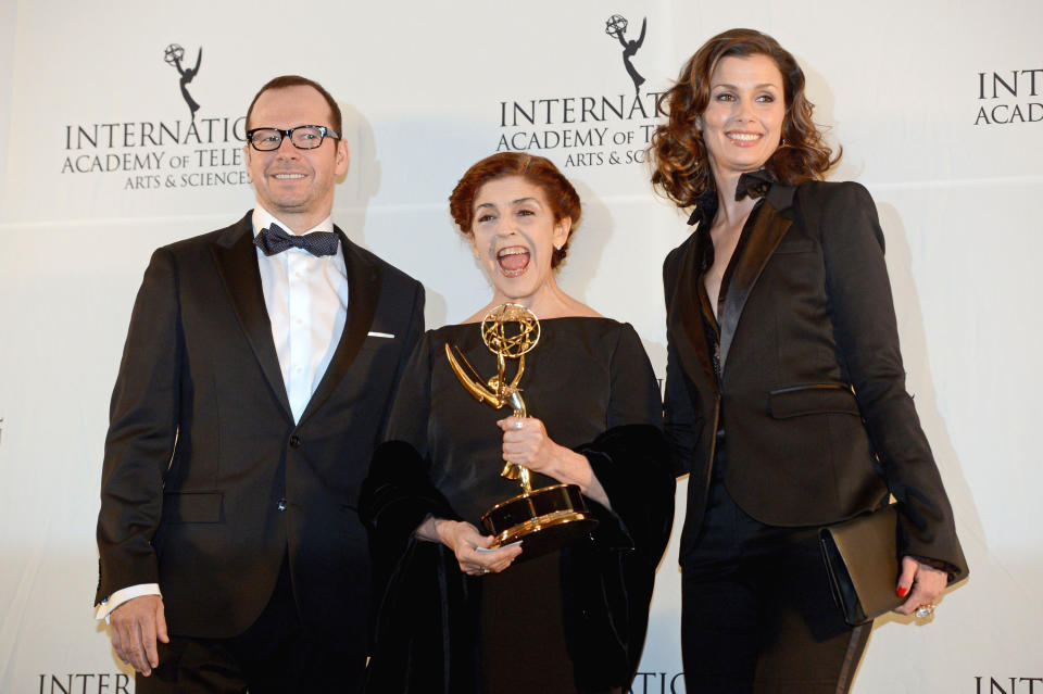 Argentine actress Cristina Banegas, center, poses with presenters Donnie Wahlberg, left, and Bridget Moynihan after winning the Best Performance by an Actress award for her role in the miniseries "Television por la Inclusion," at the 40th International Emmy Awards, Monday, Nov. 19, 2012 in New York. (AP Photo/Henny Ray Abrams)