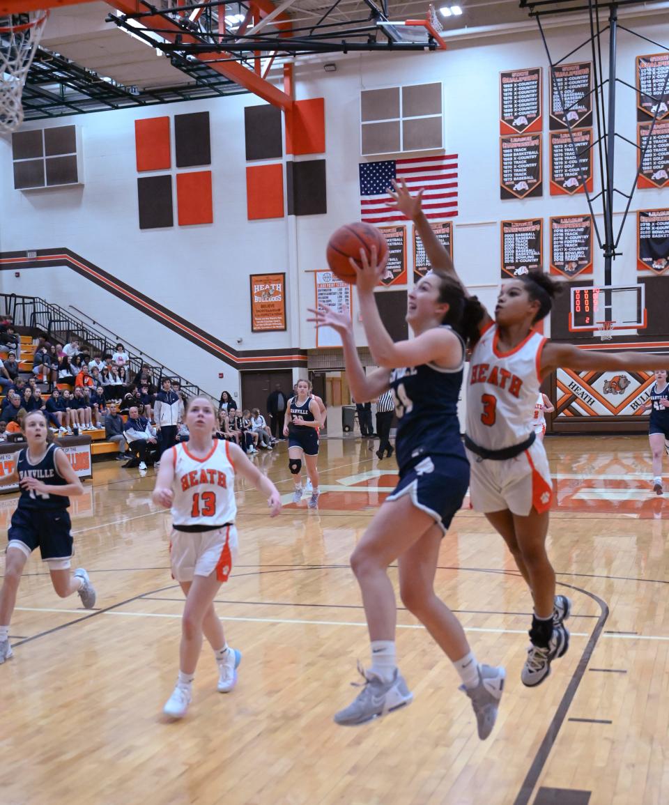 Granville's Ava Gossman goes up for a layup against Heath's Taliyah Holmes during a game in December. Granville earned the No. 1 seed for the Division II district tournament and could meet Heath again in a district semifinal.