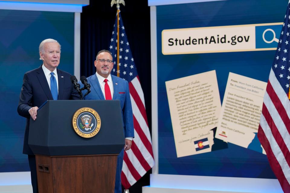 President Joe Biden and Education Secretary Miguel Cardona on Oct. 17 at the student debt relief portal beta test in the South Court Auditorium at the White House complex in Washington.