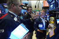 Traders confer on the floor of the New York Stock Exchange, Wednesday, Sept. 22, 2021. Stocks rose broadly on Wall Street Wednesday ahead of an update from the Federal Reserve on how and when it might begin easing its extraordinary support measures for the economy. (AP Photo/Richard Drew)