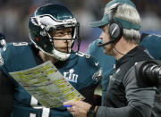 FILE - In this Feb. 4, 2018, file photo, Philadelphia Eagles head coach Doug Pederson, right, talks to Nick Foles during the first half of the NFL Super Bowl 52 football game against the New England Patriots, in Minneapolis. Facing the mighty New England Patriots on the NFL's biggest stage, Philadelphia Eagles coach Doug Pederson's decision to try a trick play _ the "Philly Special" _ on a fourth down late in the first half of Super Bowl 52 will be remembered as one of the gutsiest calls in sports history. That signature moment between Foles and Pederson standing on the sideline discussing the play was turned into a bronze statue that sits outside the team's stadium as a reminder of the greatest play in franchise history. (AP Photo/Matt York, File)