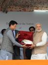 Indian prime minister Narendra Modi (R) receives a gift from Indian Energy Minister Piyush Goyal during a public rally in Kargil on August 12, 2014