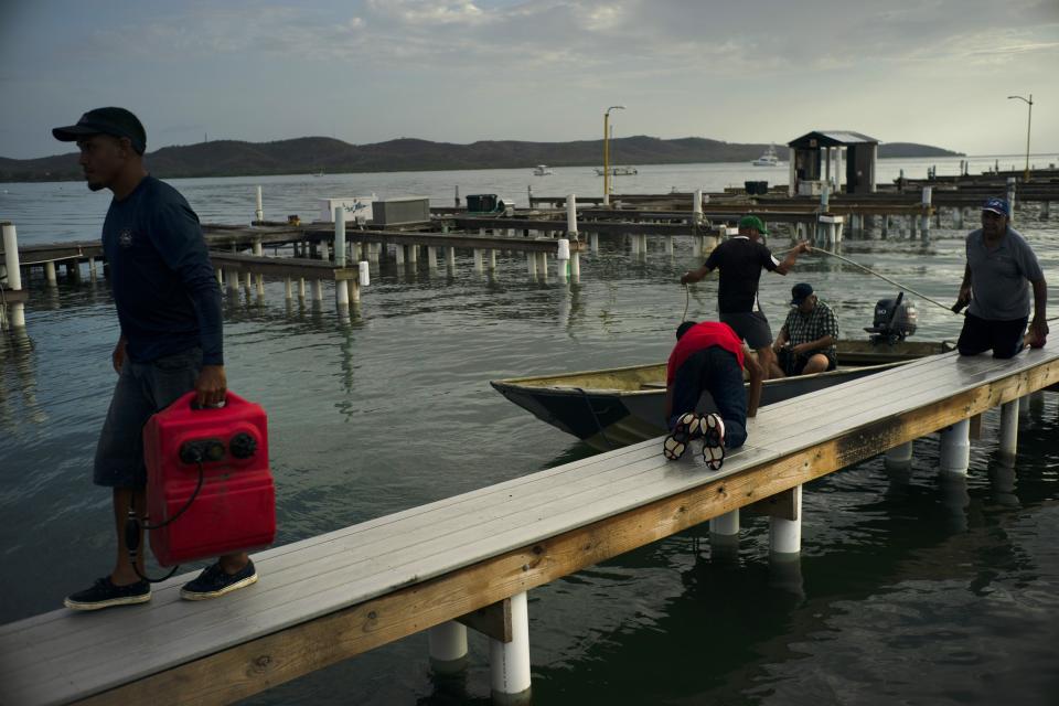 People arrive to a private harbor to move boats away for protection ahead of the arrival of Tropical Storm Dorian in Boqueron, Puerto Rico, Aug. 27, 2019. (Photo: Ramon Espinosa/AP)