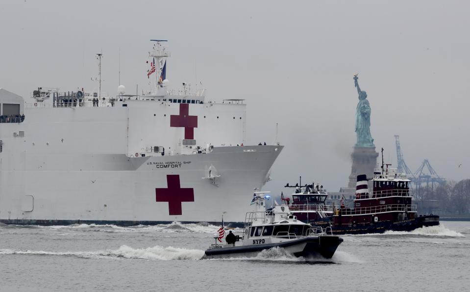 The U.S. Navy Hospital Ship Comfort makes its way past the Statue of Liberty as it sails into New York City March 30, 2020, to aid in the city's battle with the coronavirus. The ship will provide 1000 hospital beds to make room in city hospitals for COVID-19 patients.