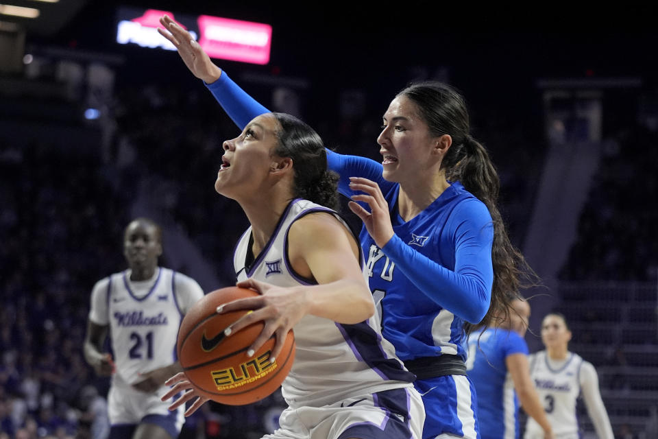 Kansas State guard Brylee Glenn, left, looks to shoot under pressure from BYU guard Kaylee Smiler during the second half of an NCAA college basketball game Saturday, Jan. 27, 2024, in Manhattan, Kan. Kansas State won 67-65. (AP Photo/Charlie Riedel)