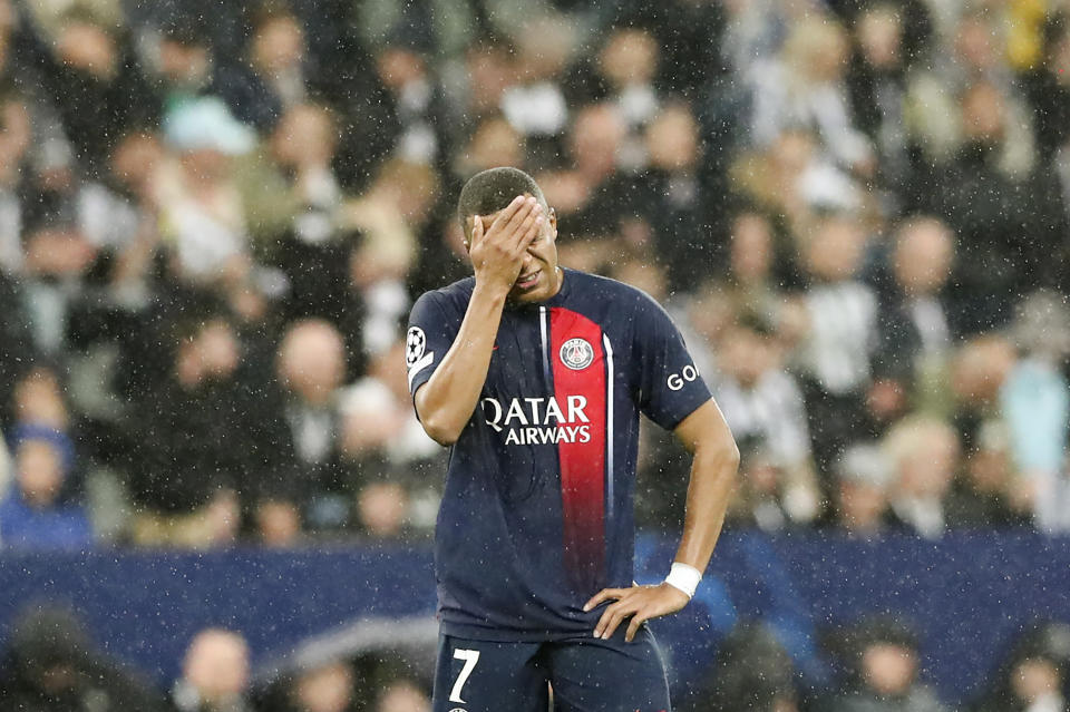 PSG's Kylian Mbappe touches his face during the Champions League group F soccer match between Newcastle and Paris Saint Germain at St. James' Park, Wednesday, Oct. 4, 2023, in Newcastle, England. (AP Photo/Scott Heppell)