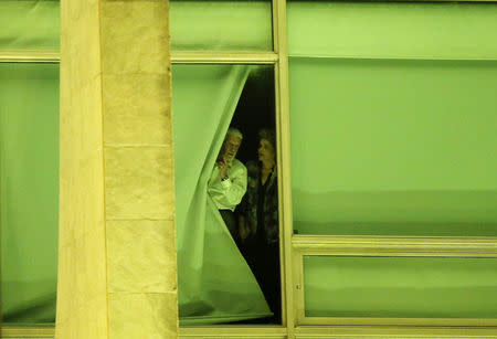 Brazil's President Dilma Rousseff, accompanied by Brazil's Chief of Staff Jaques Wagner, stand at a window at Planalto Palace in Brasilia, Brazil, May 11, 2016. REUTERS/Adriano Machado