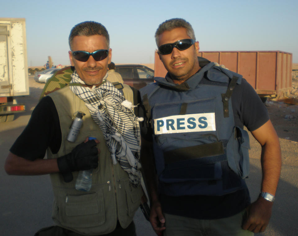 In this undated photo provided by the family of Fahmy, Mohamed Fahmy, a journalist for the Qatar-based Al-Jazeera English channel, right, poses for a photo with his friend journalist at an unknown location in Libya. Egypt’s interim President Adly Mansour told the Fahmy family of the jailed Egyptian-Canadian journalist tried on terrorism-related charges that he has instructed authorities to provide him with necessary medical attention, in a letter received Sunday, March 23, 2014. (AP Photo/Family of Fahmy)