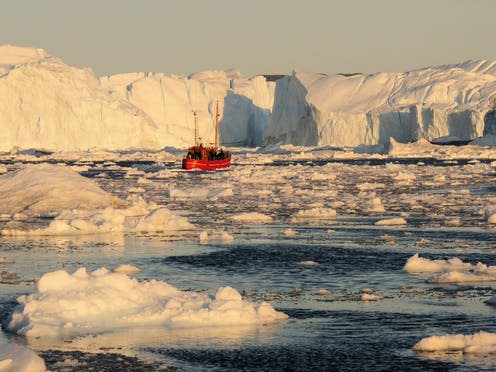 <span class="caption">A small boat in the Illulissat Icefjord is dwarfed by the icebergs that have calved from the floating tongue of Greenland's largest glacier, Jacobshavn Isbrae</span> <span class="attribution"><span class="source">Michael Bamber</span>, <span class="license">Author provided</span></span>