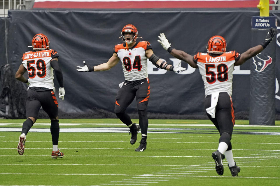 Cincinnati Bengals defensive end Sam Hubbard (94) celebrates with Akeem Davis-Gaither (59) and Carl Lawson (58) after forcing a fumble by Houston Texans quarterback Deshaun Watson during the second half of an NFL football game Sunday, The Bengals recovered the fumble and beat the Texans 37-31. (AP Photo/Sam Craft)