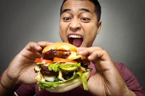 <span class="caption">It's always a bloke seen attacking a huge burger in the adverts, isn't it?</span> <span class="attribution"><span class="source">Odua Images via Shutterstock</span></span>