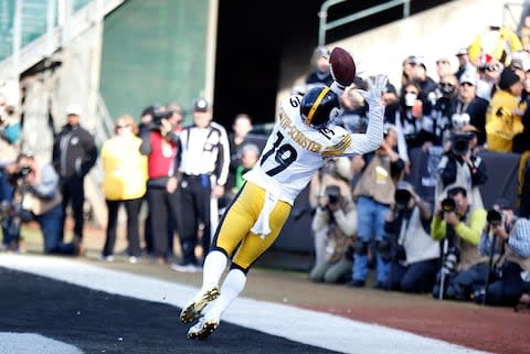 Pittsburgh Steelers wide receiver JuJu Smith-Schuster (19) catches a touchdown pass during the first half of an NFL football game against the Oakland Raiders in Oakland - Credit: AP Photo/D. Ross Cameron