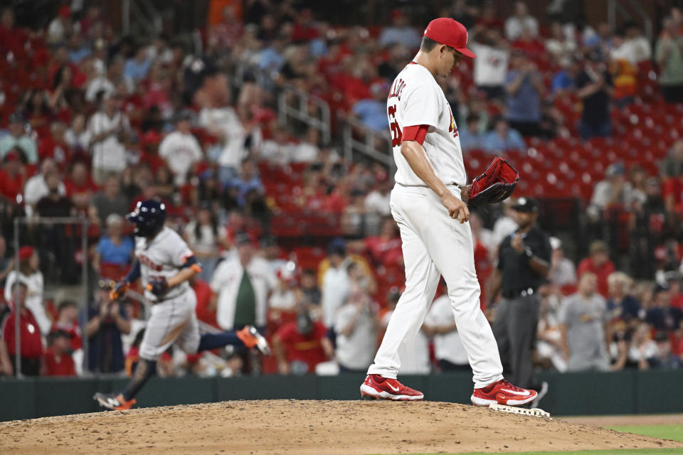 St. Louis Cardinals relief pitcher Giovanny Gallegos (65) looks on as Houston Astros second baseman Jose Altuve (27) rounds third base after hitting a three run home run during the eighth inning of a baseball game against the St. Louis Cardinals on Wednesday, June 28, 2023, in St. Louis. (AP Photo/Michael Thomas)