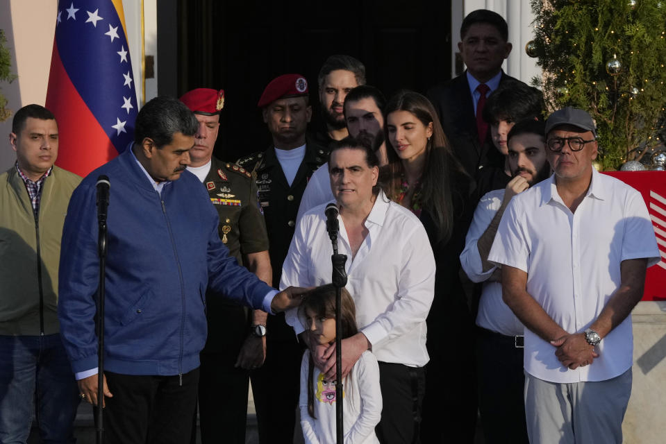 Alex Saab, center, makes a statement next to Venezuelan President Maduro, left, at Miraflores presidential palace in Caracas, Venezuela, Wednesday, Dec. 20, 2023. The United States freed Saab, who was arrested on a U.S. warrant for money laundering in 2020, in exchange for the release of 10 Americans imprisoned in Venezuela, U.S. officials said Wednesday. (AP Photo/Matias Delacroix)