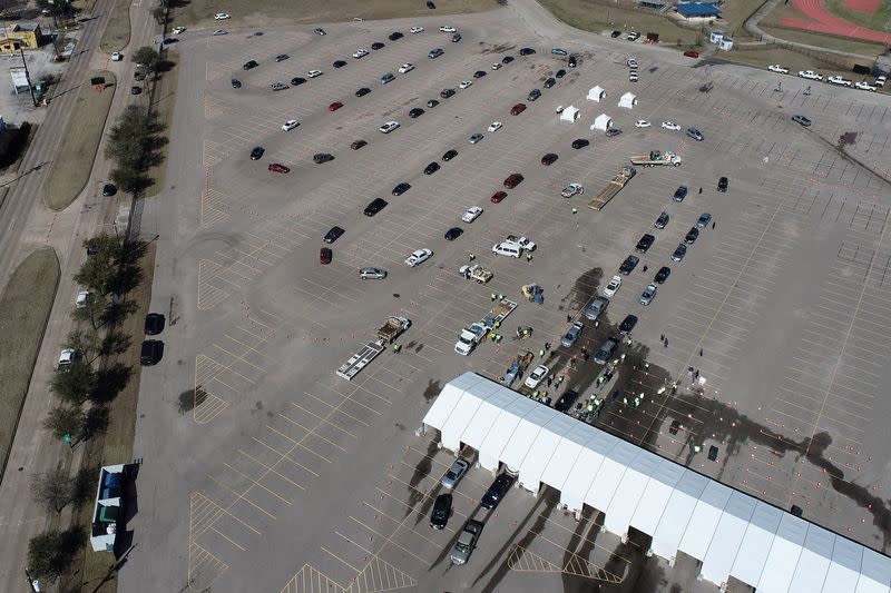 Cars line up to receive free cases of water after the city of Houston implemented a boil water advisory