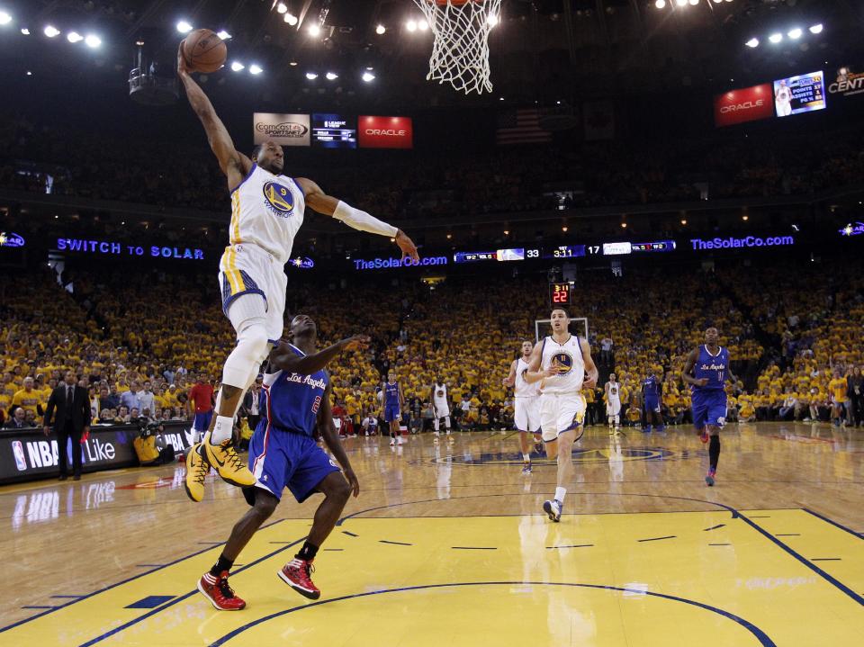 Golden State Warriors' Andre Iguodala (9) dunks past Los Angeles Clippers' Darren Collison (2) during the first half in Game 4 of an opening-round NBA basketball playoff series on Sunday, April 27, 2014, in Oakland, Calif. (AP Photo/Marcio Jose Sanchez)