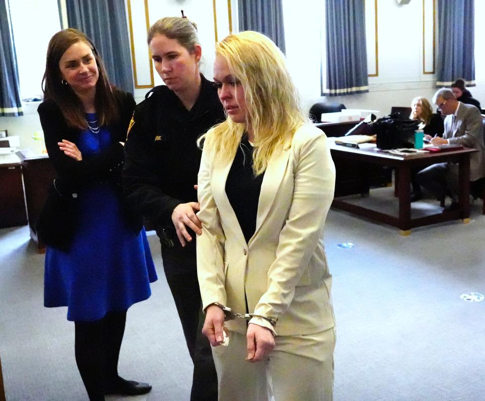 Samantha Davis is led away in handcuffs following her sentencing Monday in front of Hamilton County Common Pleas Judge Leslie Ghiz. Her attorney, Kara Blackney, is at left. Davis was sentenced to 64 months, but was credited for the three years, seven months she’s already served in the fatal crash in 2016 that killed two. Her original conviction was overturned two years ago.