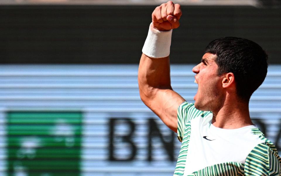 Carlos Alcaraz Garfia celebrates a point against Serbia's Novak Djokovic during their men's singles semi-final match on day thirteen of the Roland-Garros Open tennis tournament at the Court Philippe-Chatrie - EMMANUEL DUNAND/AFP via Getty Images