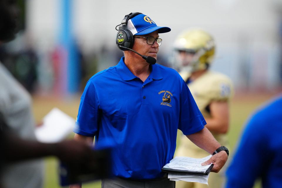 Cardinal Newman High head football coach Jack Daniels walks along the sideline Thursday during the game against Pahokee.