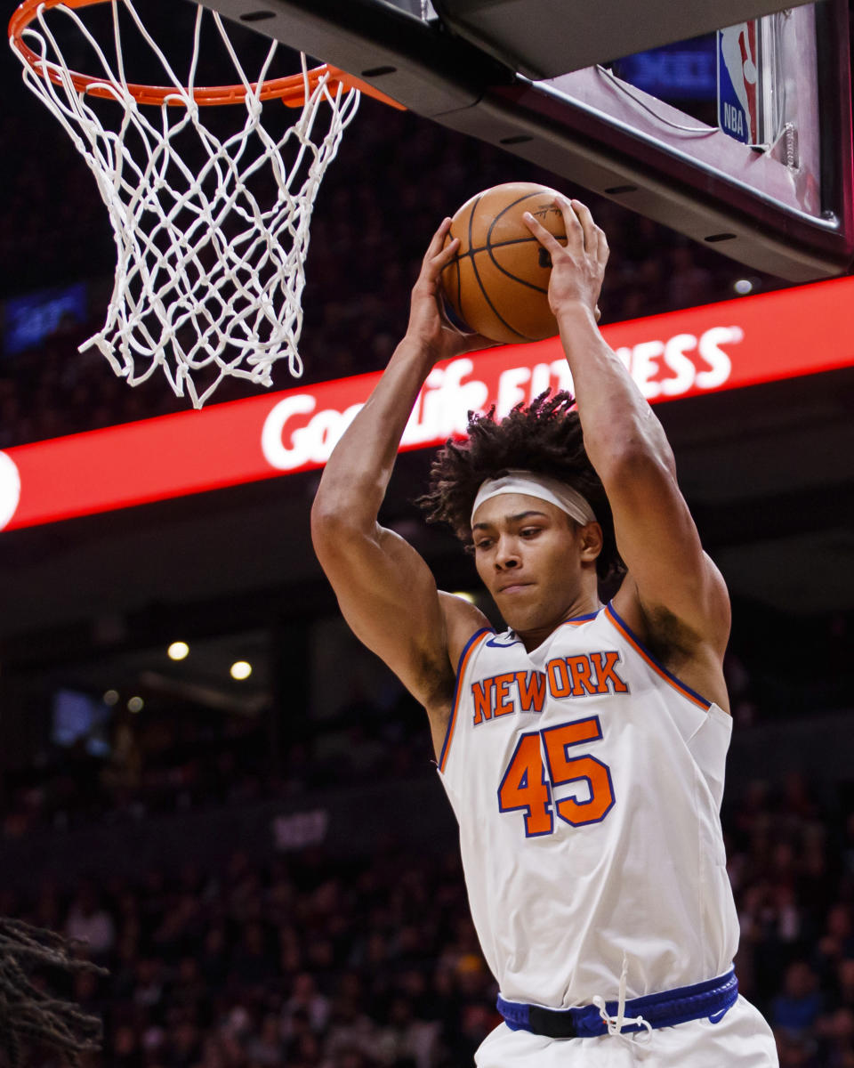 New York Knicks center Jericho Sims (45) grabs a rebound against the Toronto Raptors during the first half of an NBA basketball game Friday, Jan. 6, 2023, in Toronto. (Cole Burston/The Canadian Press via AP)