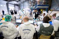 Forensic experts of the French gendarmerie disaster victim identification unit (UGIVC) work under a tent near the site of the crash of a Germanwings Airbus A320 in which all 150 people on board were killed