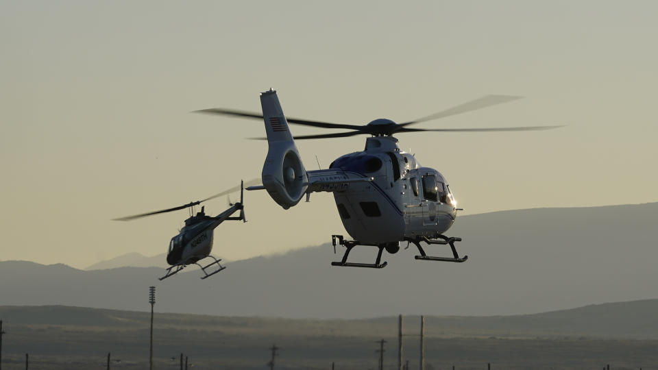 Helicopter recovery teams depart the Michael Army Air Field before the arrival of a space capsule carrying NASA's first asteroid samples on Sunday, Sept. 24, 2023, to a temporary clean room at Dugway Proving Ground, in Utah. The Osiris-Rex spacecraft released the capsule following a seven-year journey to asteroid Bennu and back. (AP Photo/Rick Bowmer)