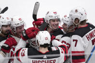 New Jersey Devils' Jack Hughes (86) celebrates Jonas Siegenthaler (71), Fabian Zetterlund (49), Nico Hischier (13), Jesper Bratt (63) and Dougie Hamilton (7) after scoriung in overtime of an NHL hockey game against the Dallas Stars, Friday, Jan. 27, 2023, in Dallas. The Devils won 3-2. (AP Photo/Tony Gutierrez)