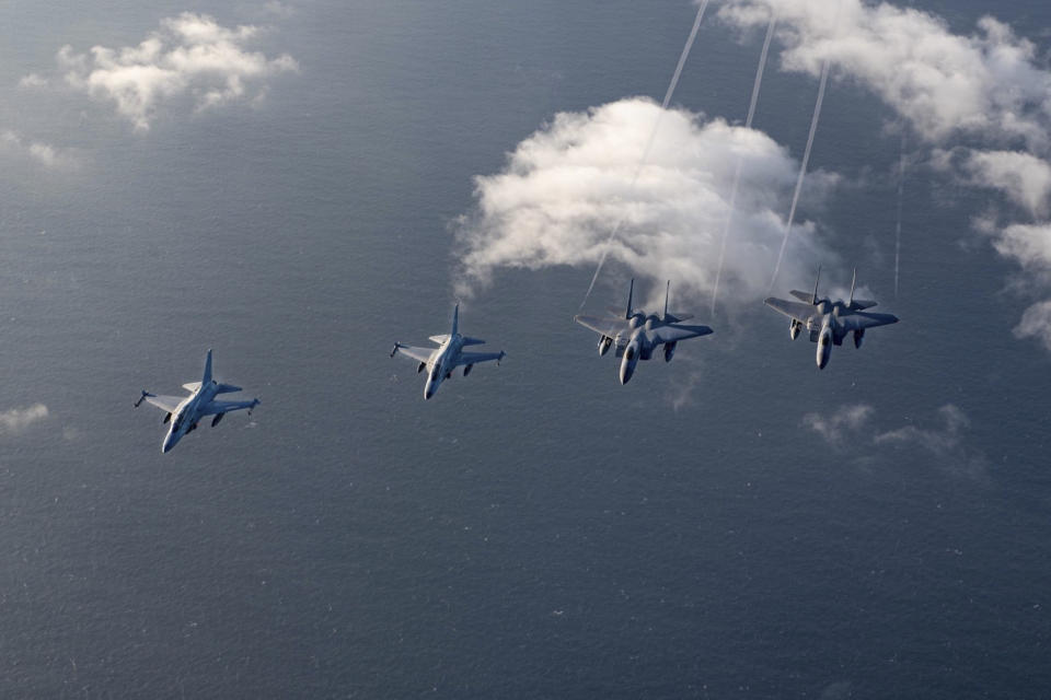 In this handout photo released by the Philippine Air Force, Philippine Air Force FA-50PH jet fighters, left and second from left, join the maritime patrol of the Philippines and the United States over Batanes and areas in the West Philippine Sea on Tuesday, Nov. 21, 2023. The United States and Philippines are conducting joint air and maritime patrols in the South China Sea, which come as the two countries step up cooperation in the face of growingly aggressive Chinese activity in the area. (Philippine Air Force via AP)