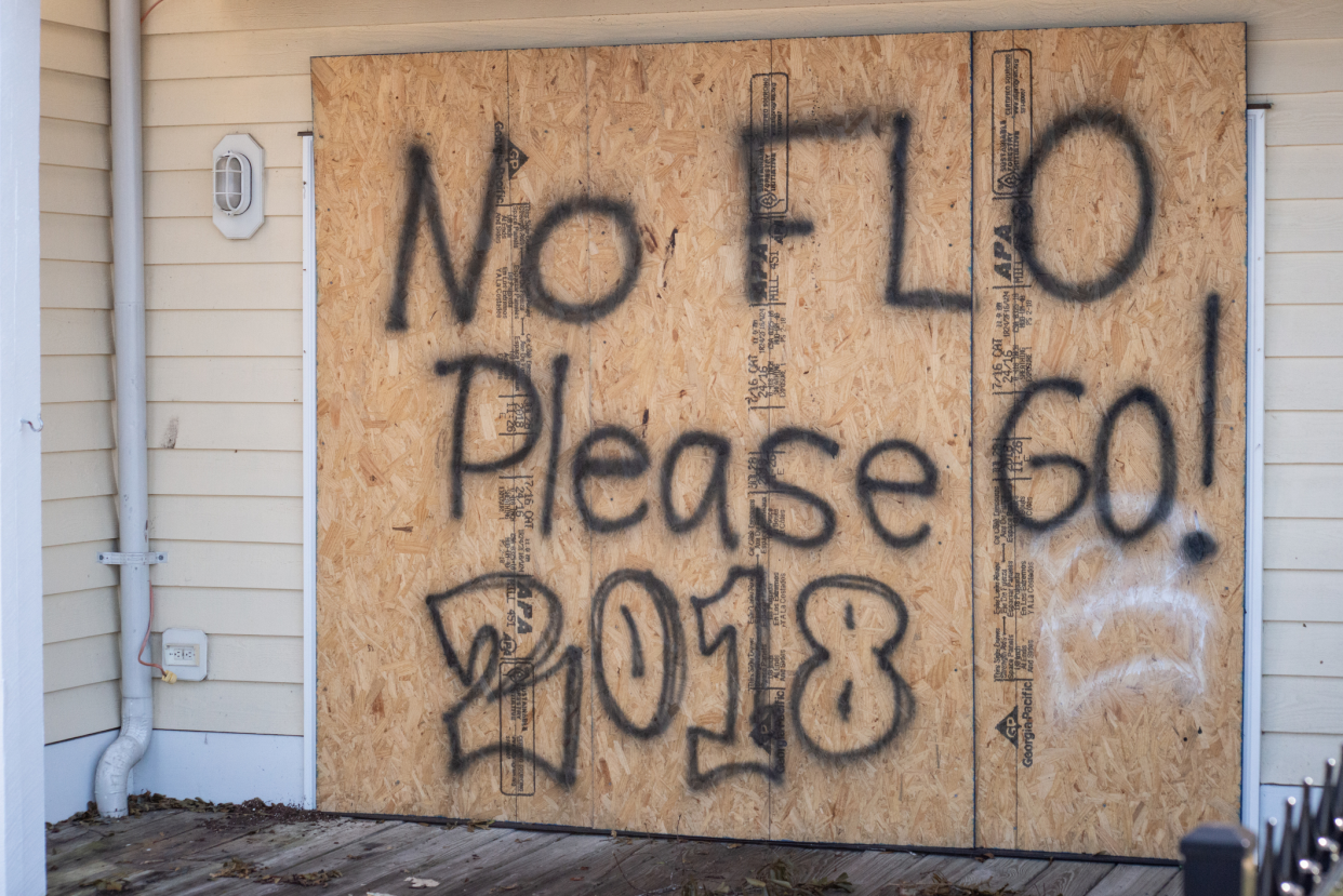 Boarded up windows marked 'No FLO, Please GO!' 2018' in Wilmington, North Carolina, during Hurricane Florence, 2018