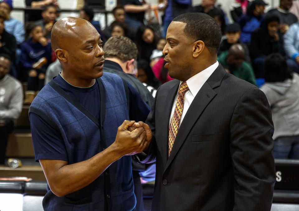 Ron Ingram, left, talks with Lanphier coach Blake Turner during a boys basketball game in Springfield. Ingram, a Manual grad, will take over the boys basketball program at Peoria Quest.