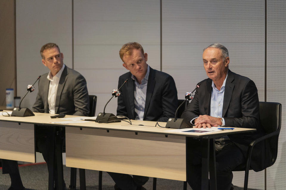 Major League Baseball Commissioner Rob Manfred, right, speaks during a news conference at Major League Baseball's headquarters on Friday, Sept. 9, 2022. (AP Photo/Jeenah Moon)