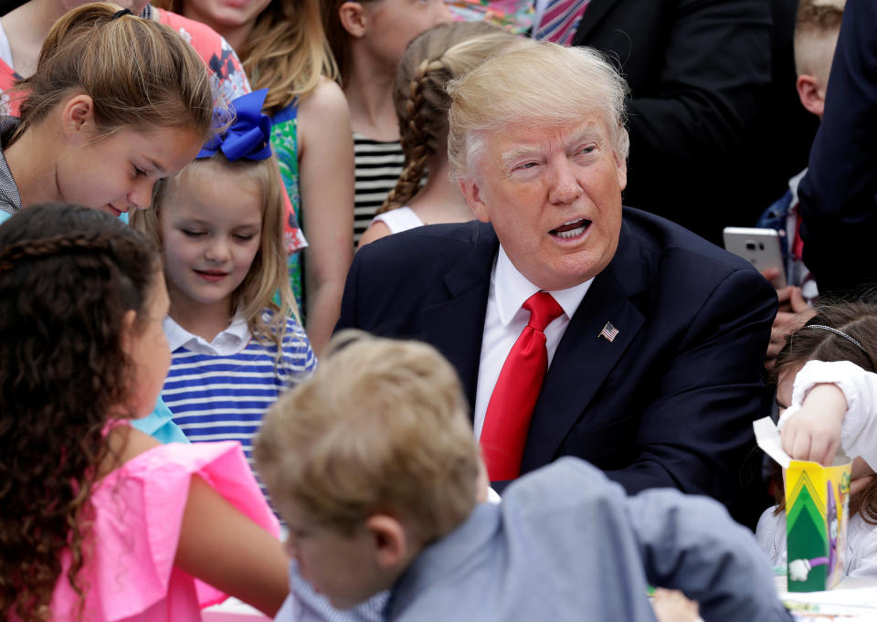 U.S. President Donald Trump speaks with children as they make Easter greeting cards for members of the military at the 139th annual White House Easter Egg Roll on the South Lawn of the White House in Washington, U.S., April 17, 2017. REUTERS/Joshua Roberts