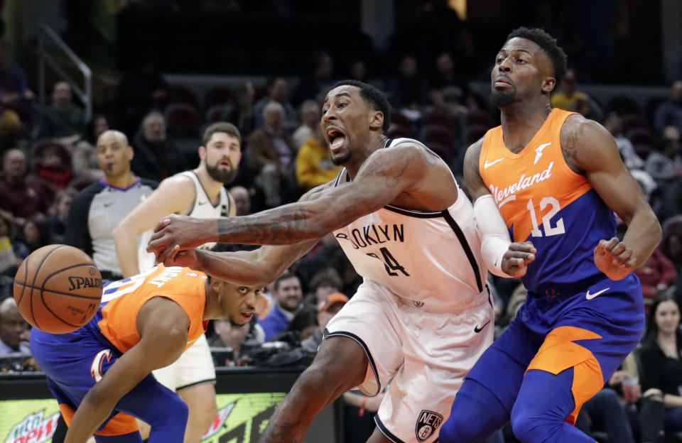 Brooklyn Nets' Rondae Hollis-Jefferson (24) loses control of the ball against Cleveland Cavaliers' David Nwaba (12) in the first half of an NBA basketball game, Wednesday, Feb. 13, 2019, in Cleveland. (AP Photo/Tony Dejak)