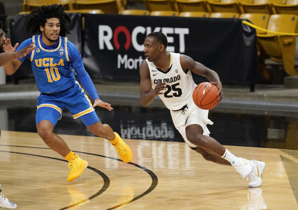 Colorado guard McKinley Wright IV, right, drives past UCLA guard Tyger Campbell in the first half of an NCAA college basketball game Saturday, Feb. 27, 2021, in Boulder, Colo. (AP Photo/David Zalubowski)