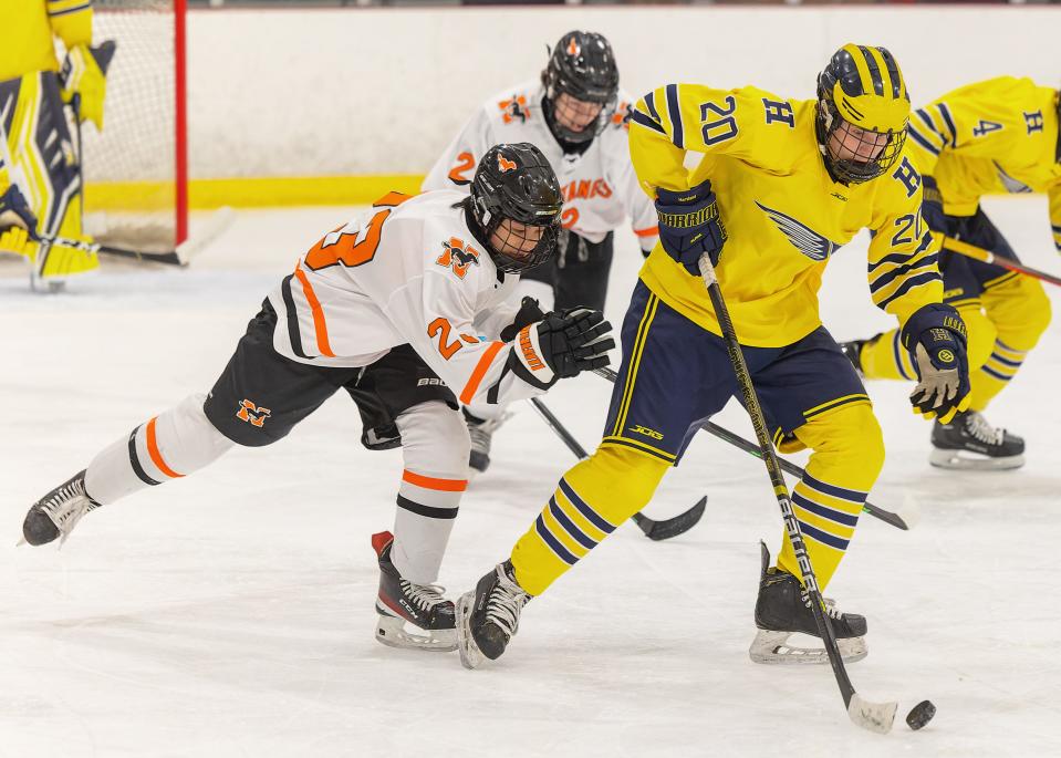 Hartland's James Storm (20) is pursued by Northville's Ryan Lin during the Eagles' 6-1 victory on Wednesday, Jan. 4, 2023 at Hartland Sports Center.