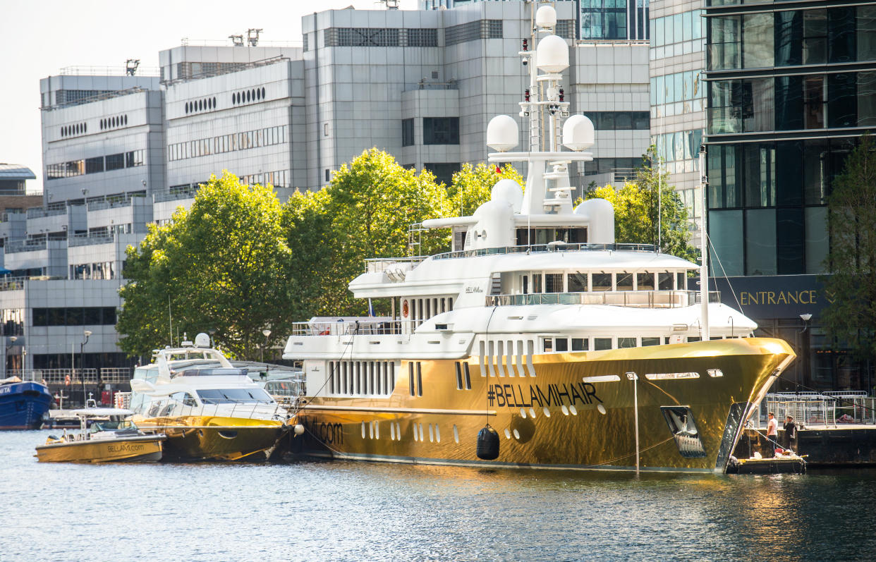 Ostentatious: The superyacht has been encased in gold vinyl. (SWNS)