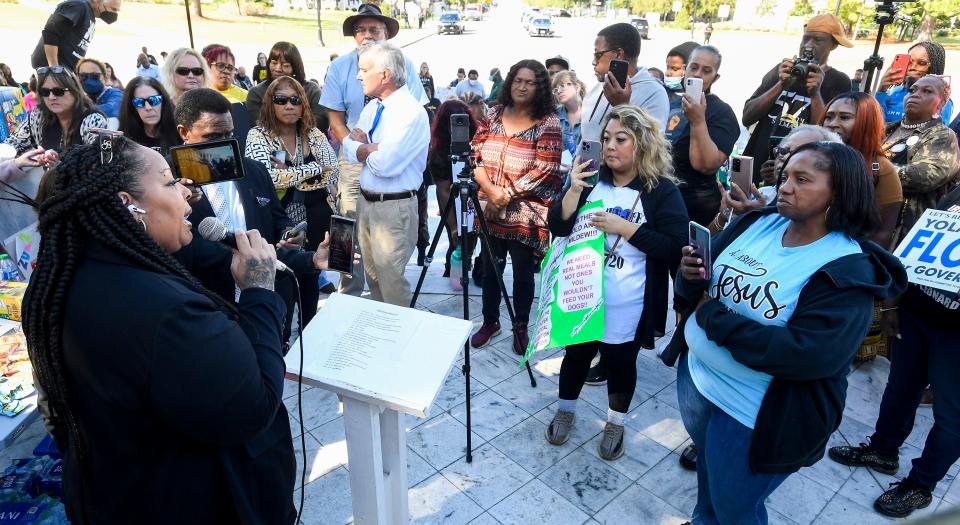 Diyawn Caldwell, left, speaks during the Break Every Chain Rally on the Alabama Capitol steps in Montgomery on Oct. 14, 2022. The protestors were asking for prison and parole improvements.