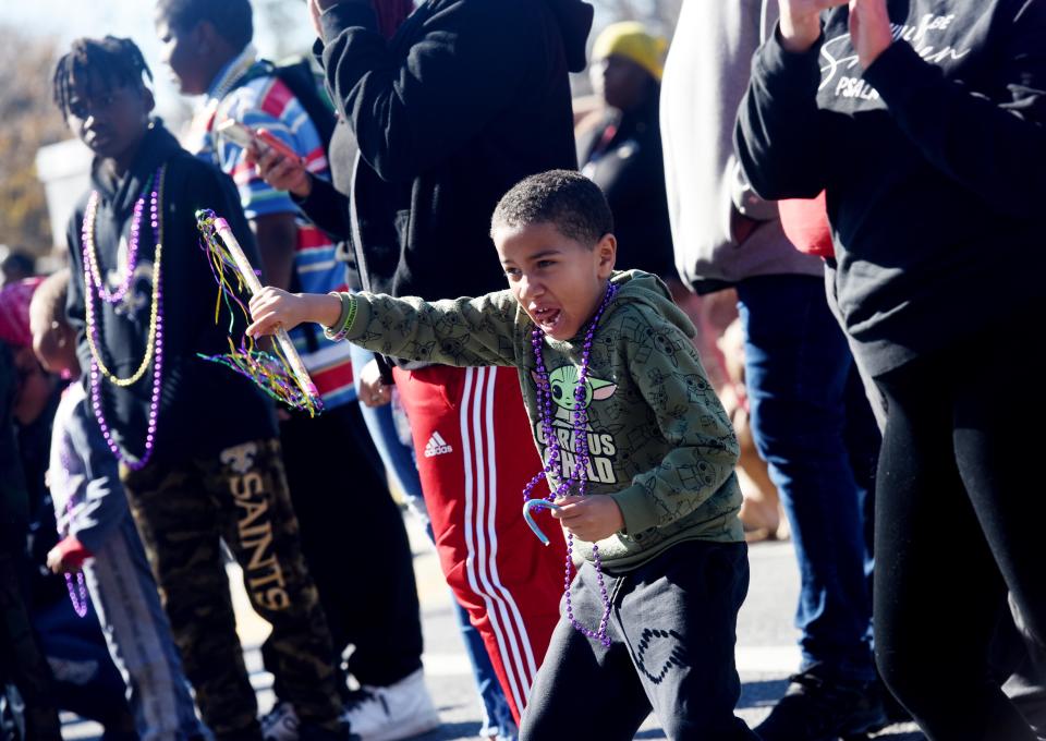  Luke Jewitt twirls the baton that he was given during the Krewe of Harambee annual Martin Luther King Jr. Day parade January 17, 2022.