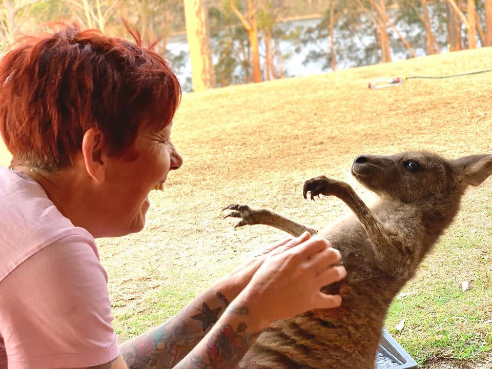 Around Australia, cute kangaroos like this one pictured with Rae Harvey are being shot and turned into pet food. Source: Wild2Free