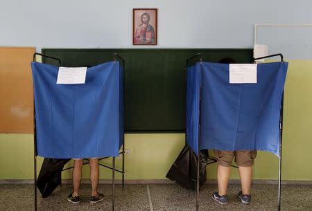 Athenians are seen inside polling booths at a school in Athens, Greece July 5, 2015. REUTERS/Yannis Behrakis