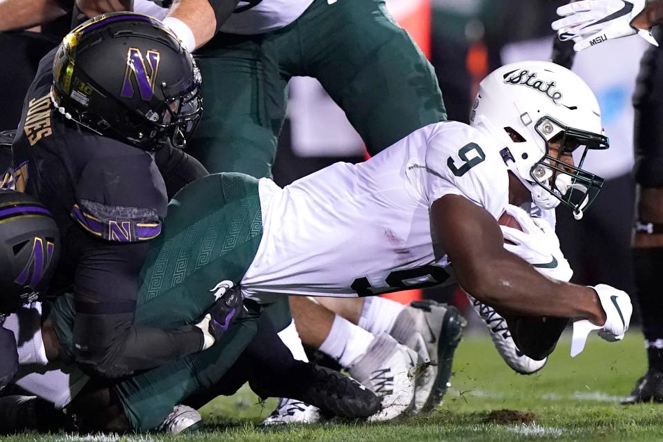 Michigan State running back Kenneth Walker III., right, is tackled by Northwestern linebacker Khalid Jones during the first half on Friday, Sept. 3, 2021, in Evanston, Illinois.