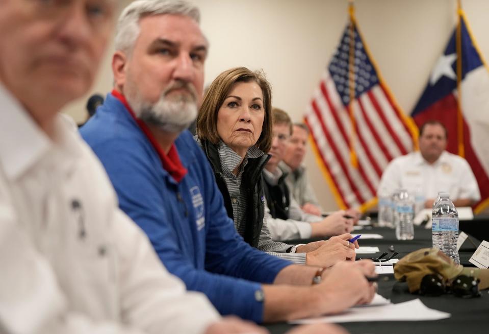 Iowa Gov. Kim Reynolds listens at a news conference about border policies Sunday. Reynolds was one of 12 GOP governors, including Greg Abbott, who assembled in Eagle Pass to criticize the federal response to an increase in immigrants crossing the U.S.-Mexico border.