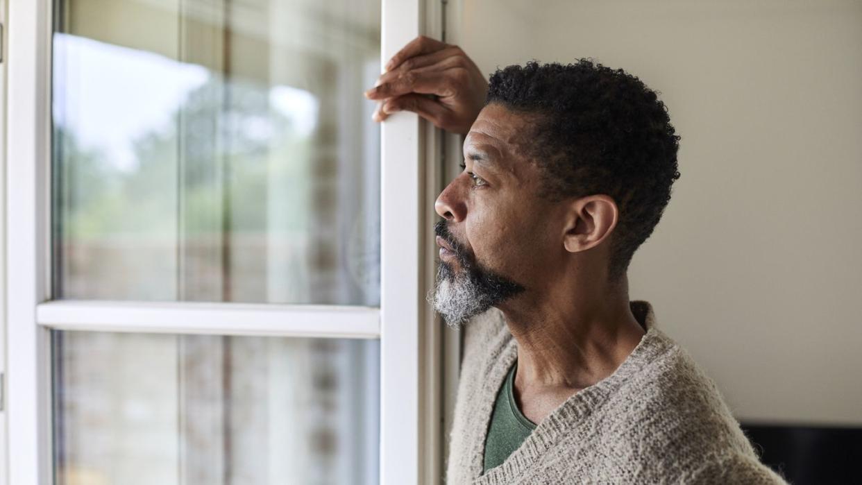 pensive man looking out of window