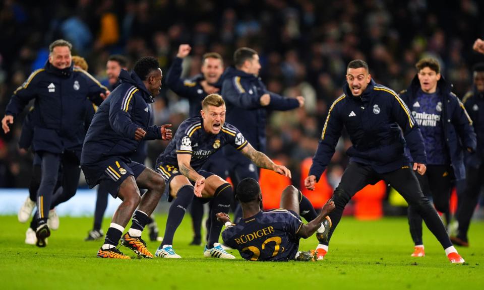 <span>Real Madrid players race to Antonio Rüdiger after his successful penalty earns a 4-3 shootout triumph.</span><span>Photograph: Mike Egerton/PA</span>